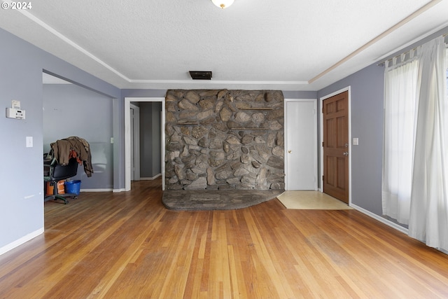 unfurnished living room featuring hardwood / wood-style floors and a textured ceiling