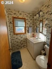 bathroom featuring tile patterned floors, vanity, and toilet