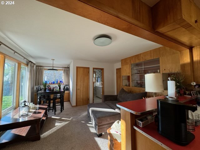 kitchen featuring carpet flooring, decorative light fixtures, and kitchen peninsula