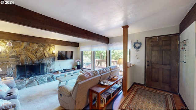 living room featuring a fireplace and beamed ceiling