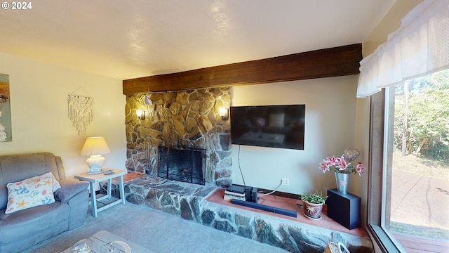 living room with a stone fireplace and carpet flooring