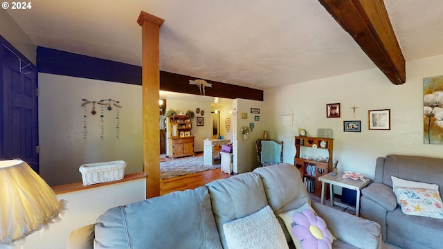 living room with beam ceiling and hardwood / wood-style flooring