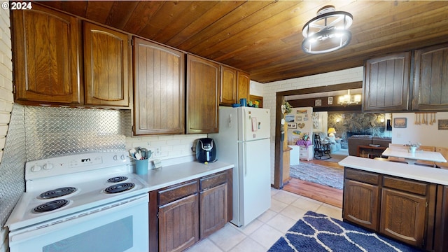 kitchen featuring wooden ceiling, backsplash, light tile patterned floors, and white appliances