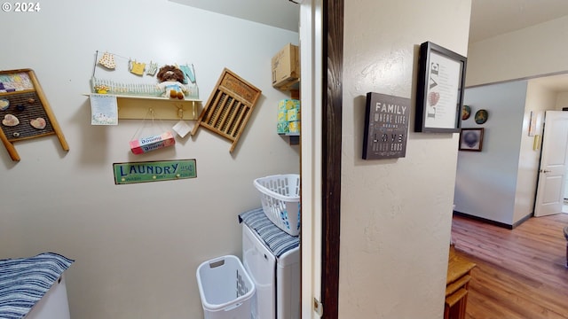 clothes washing area featuring washer / clothes dryer and hardwood / wood-style floors