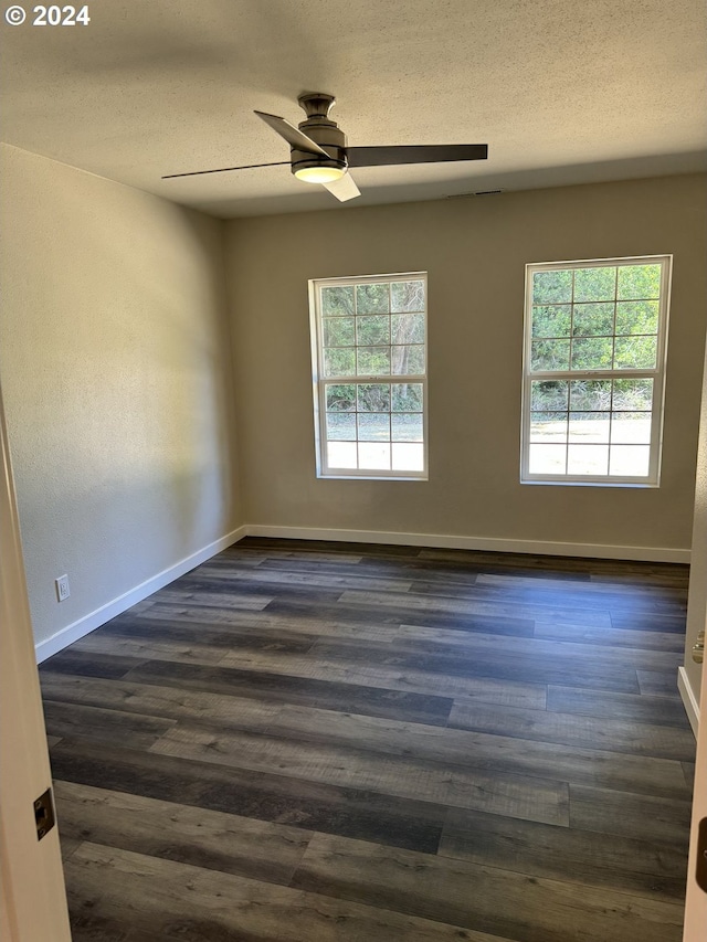 unfurnished room with dark hardwood / wood-style floors and a healthy amount of sunlight