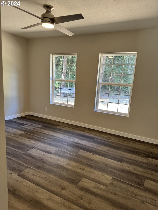 spare room with ceiling fan, dark hardwood / wood-style floors, and a textured ceiling