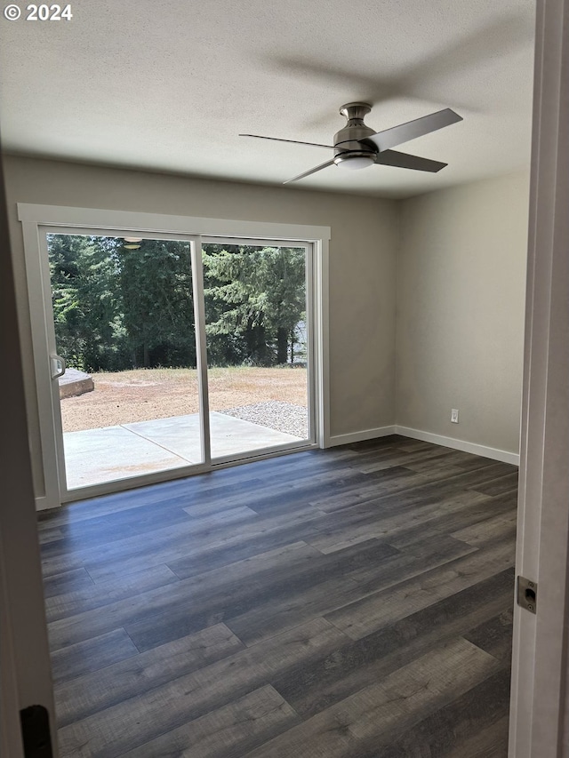 empty room featuring a textured ceiling, dark hardwood / wood-style floors, and ceiling fan