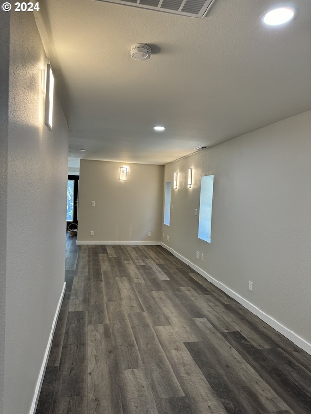 spare room featuring dark wood-type flooring