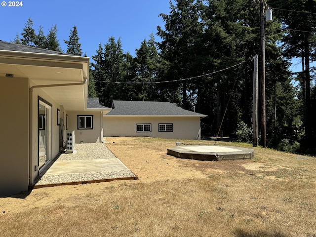 view of yard with central AC unit and a patio area