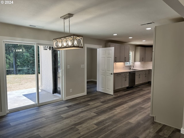 kitchen with gray cabinetry, dishwasher, pendant lighting, dark hardwood / wood-style floors, and sink