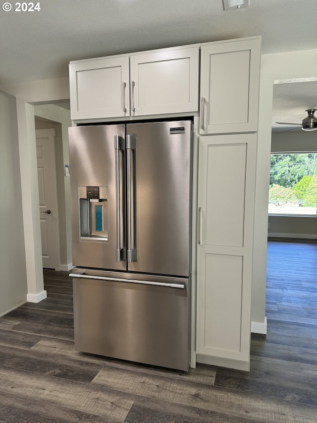 kitchen with white cabinetry, a textured ceiling, dark hardwood / wood-style floors, and stainless steel fridge with ice dispenser