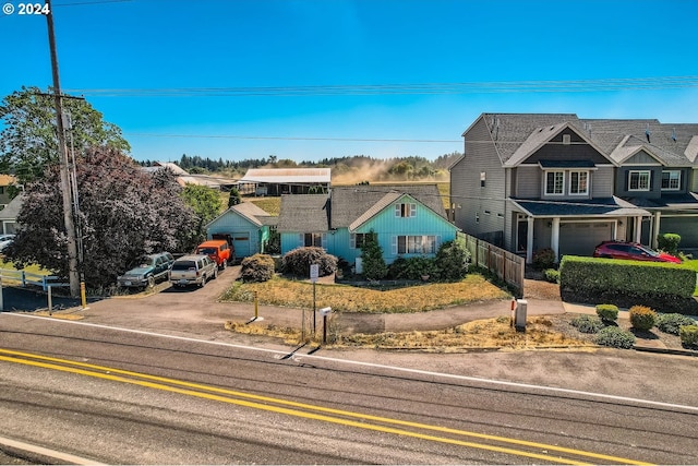 view of front facade with a garage, fence, and driveway