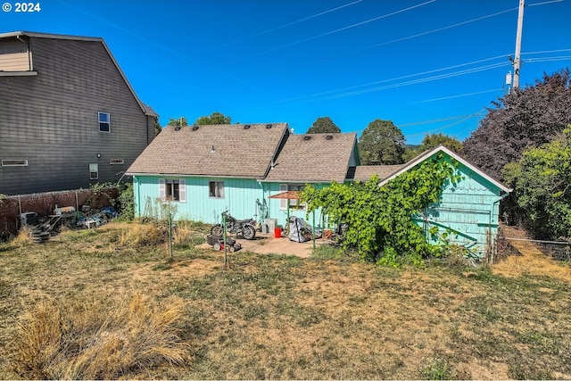 back of property with a lawn