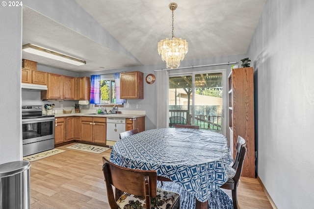 kitchen with light hardwood / wood-style floors, plenty of natural light, a notable chandelier, and stainless steel electric range