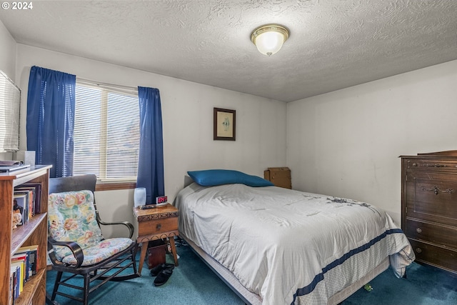 carpeted bedroom with a textured ceiling