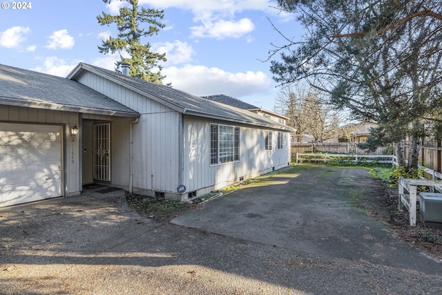 view of side of home with a garage