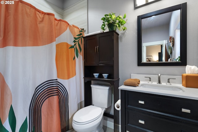 bathroom featuring vanity, curtained shower, and toilet