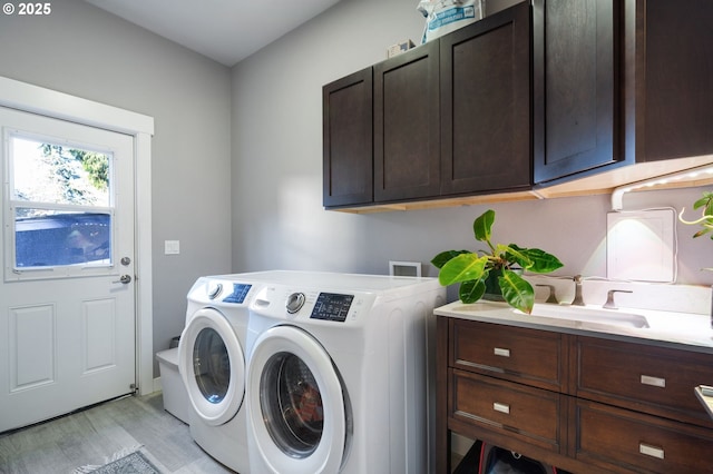 215 NE 30th Ave, Portland, OR 97232 - laundry area with cabinet space, washer and clothes dryer, and light wood-style floors