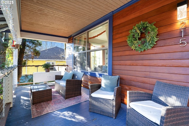 wooden terrace featuring an outdoor hangout area