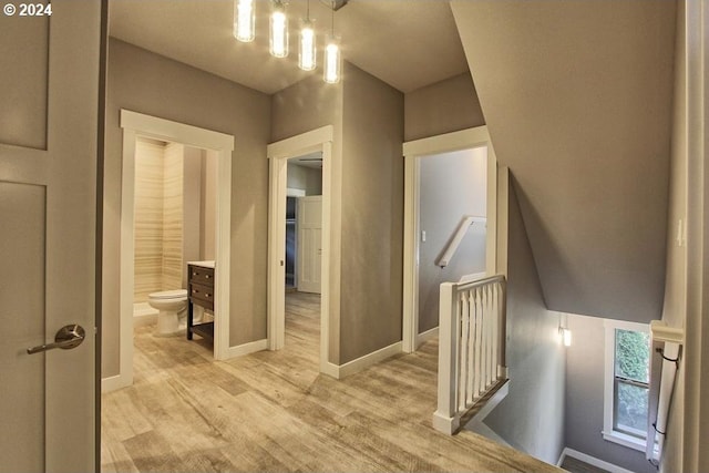 215 NE 30th Ave, Portland, OR 97232 - hall with an upstairs landing, light wood-style floors, and a chandelier