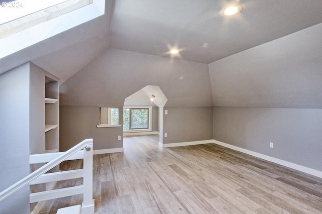 215 NE 30th Ave, Portland, OR 97232 - additional living space featuring wood finished floors, a skylight, and vaulted ceiling