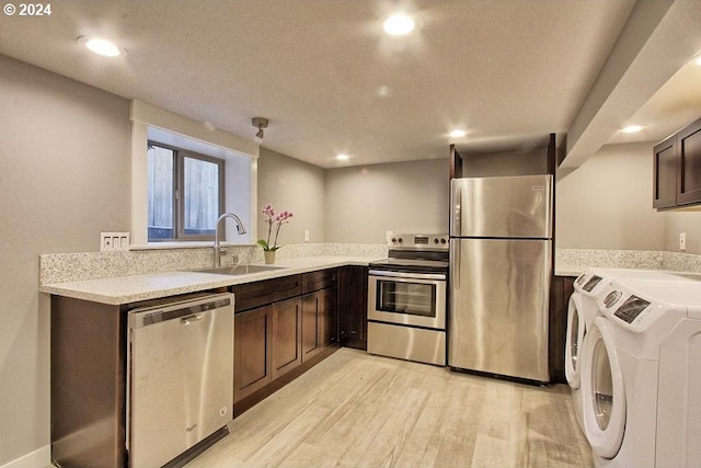 215 NE 30th Ave, Portland, OR 97232 - kitchen with stainless steel appliances, light wood finished floors, washer and clothes dryer, dark brown cabinetry, and recessed lighting