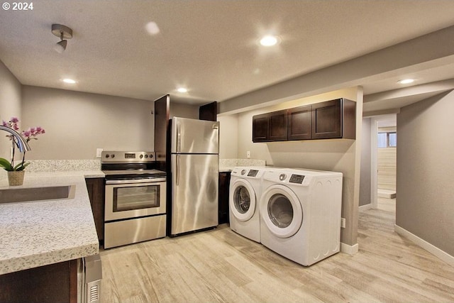 215 NE 30th Ave, Portland, OR 97232 - laundry room featuring washing machine and dryer, light wood finished floors, and recessed lighting