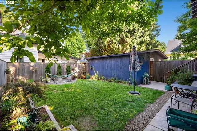 215 NE 30th Ave, Portland, OR 97232 - fenced backyard featuring a patio area and an outbuilding