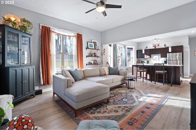 living room featuring ceiling fan and light hardwood / wood-style flooring