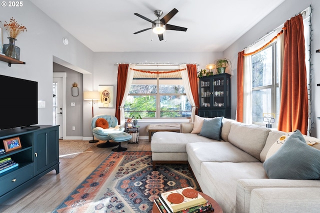 living room featuring light hardwood / wood-style floors and ceiling fan