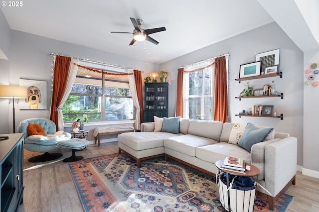 living room with light hardwood / wood-style floors and ceiling fan