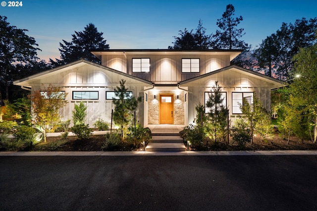 view of front of home featuring board and batten siding and stone siding