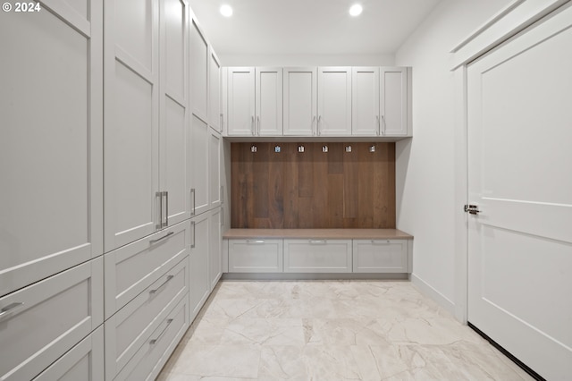 mudroom with recessed lighting and marble finish floor