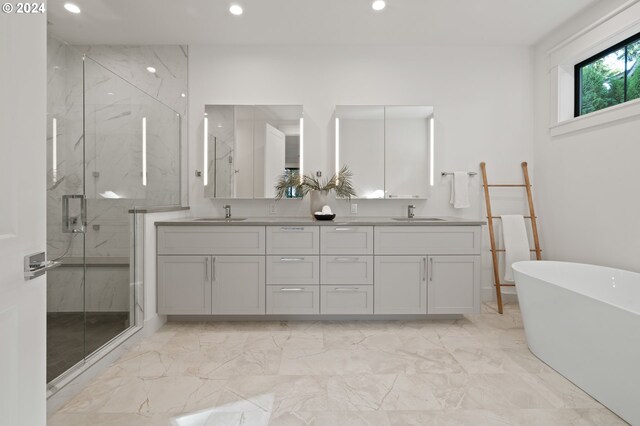 bathroom featuring vanity and separate shower and tub