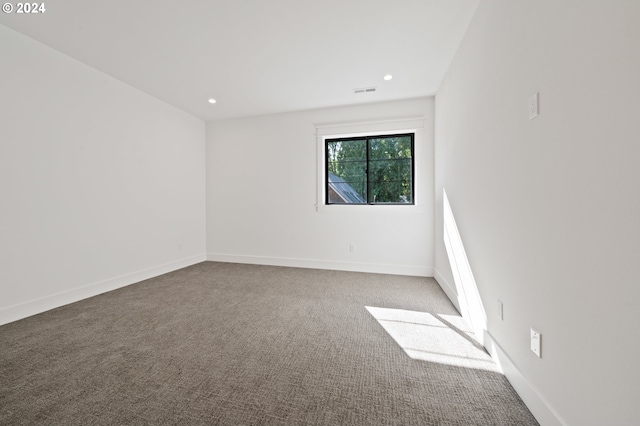 empty room with carpet floors, recessed lighting, and baseboards