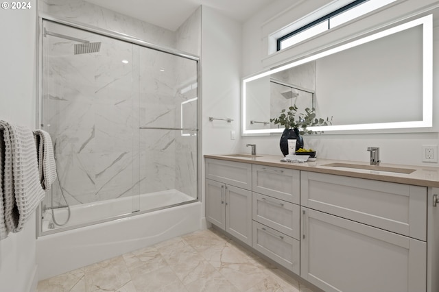 bathroom with double vanity, shower / bath combination with glass door, marble finish floor, and a sink