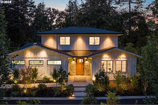 view of front facade with stone siding and board and batten siding