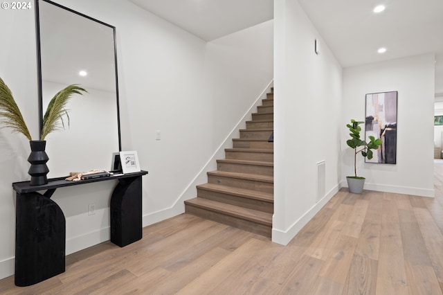 stairs with hardwood / wood-style flooring