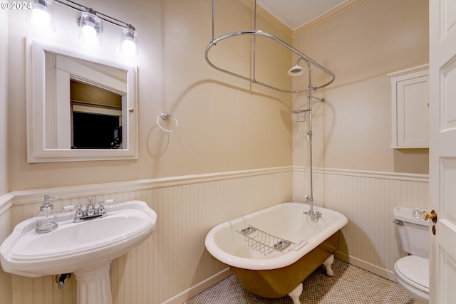 bathroom featuring sink, tile flooring, crown molding, and toilet