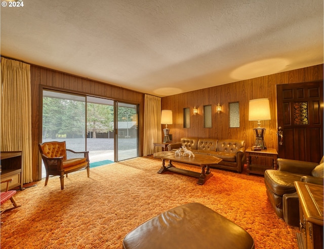 living room featuring light carpet, wood walls, and a textured ceiling