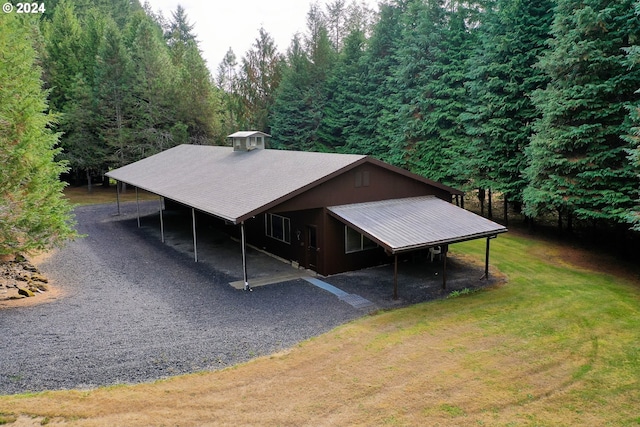 exterior space with a lawn and a carport