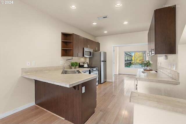 spare room featuring a textured ceiling and light hardwood / wood-style flooring