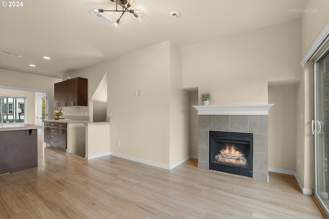 unfurnished living room featuring a fireplace and light hardwood / wood-style flooring