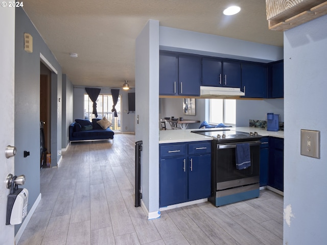 kitchen with blue cabinetry, light hardwood / wood-style flooring, kitchen peninsula, ceiling fan, and stainless steel electric stove