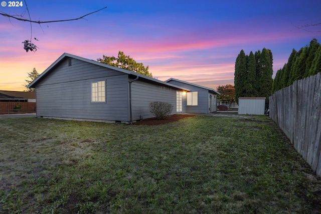 back house at dusk with a yard