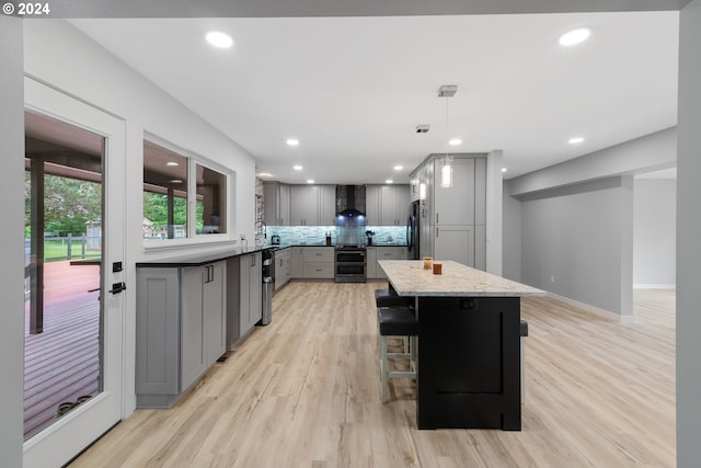 kitchen with fridge, pendant lighting, backsplash, and gray cabinets