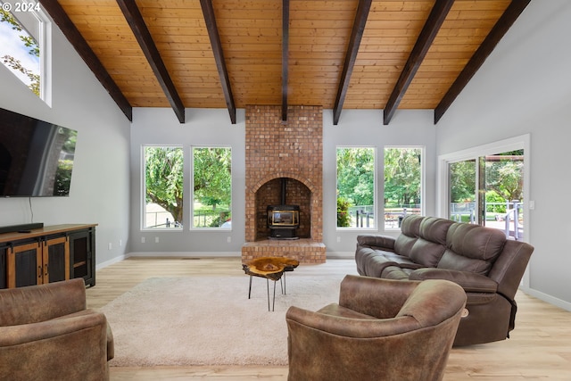 living room featuring wooden ceiling, a wood stove, light hardwood / wood-style flooring, and vaulted ceiling with beams