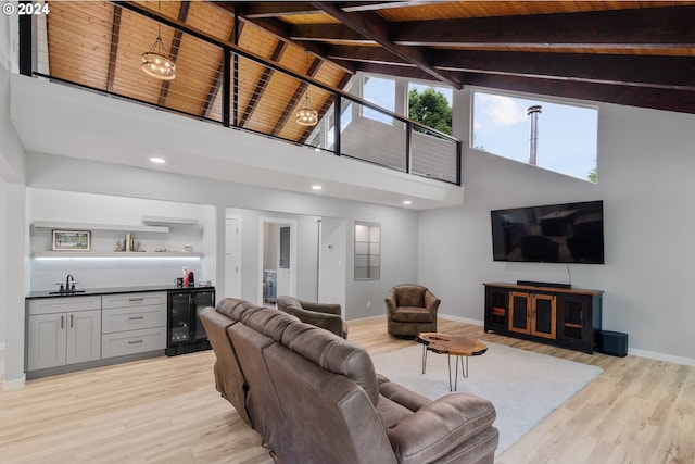 living room featuring wine cooler, high vaulted ceiling, wet bar, wooden ceiling, and light hardwood / wood-style flooring