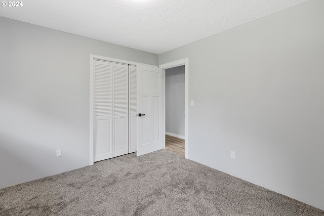 unfurnished bedroom with carpet floors and a closet