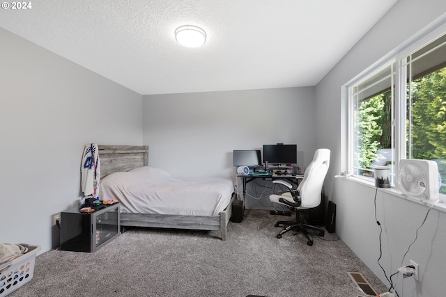 bedroom with a textured ceiling and carpet floors